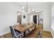Bright dining room features a modern chandelier and a wooden table with bench seating at 11907 Ledgestone Cir, Fishers, IN 46037