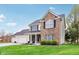 Charming two-story home with brick and siding, complemented by a lush green lawn and inviting curb appeal at 11907 Ledgestone Cir, Fishers, IN 46037
