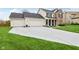 Beautiful home with an extra-long driveway, three-car garage, and manicured lawn, offering space and curb appeal at 11907 Ledgestone Cir, Fishers, IN 46037