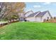 Well-maintained home exterior with a spacious backyard, screened porch, and lush landscaping at 11907 Ledgestone Cir, Fishers, IN 46037