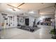 Well-organized garage with a home gym setup, storage solutions, and clean epoxy flooring at 11907 Ledgestone Cir, Fishers, IN 46037