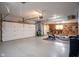 Spacious garage with ample storage space, workshop area, and exercise equipment at 11907 Ledgestone Cir, Fishers, IN 46037
