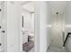 Hallway offers a peek into the bathroom, enhanced by a modern light fixture creating a bright space at 11907 Ledgestone Cir, Fishers, IN 46037