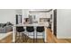 Kitchen island with seating, granite counters, and stainless appliances, connecting to other living areas at 11907 Ledgestone Cir, Fishers, IN 46037