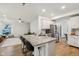 Kitchen island offers bar seating, stainless appliances, and open access to the living room at 11907 Ledgestone Cir, Fishers, IN 46037