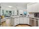 Bright kitchen island with bar seating, granite counters, stainless appliances, and sliding glass door access to the patio at 11907 Ledgestone Cir, Fishers, IN 46037