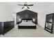 Cozy main bedroom with a dark accent wall and comfortable furnishings at 11907 Ledgestone Cir, Fishers, IN 46037