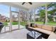 Inviting screened-in porch with a comfortable seating area and views of the lush backyard at 11907 Ledgestone Cir, Fishers, IN 46037