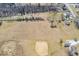 This aerial view shows the property with a pond and baseball diamond at 1229 N German Church Rd, Indianapolis, IN 46229