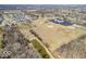This aerial view shows the property with pond, baseball diamond, and treescapes at 1229 N German Church Rd, Indianapolis, IN 46229