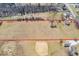 This aerial view shows the property outlined in red with a pond and baseball diamond at 1229 N German Church Rd, Indianapolis, IN 46229
