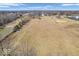 This aerial view shows the property with waterway and treescapes at 1229 N German Church Rd, Indianapolis, IN 46229