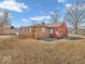 Cozy single-story home with a combination of wood and brick exterior nestled on a large lot at 1229 N German Church Rd, Indianapolis, IN 46229