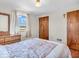 This bedroom boasts wood floors, natural light, closet space and a soft patterned bedspread at 1229 N German Church Rd, Indianapolis, IN 46229