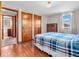 This bedroom features hardwood floors, two closets, and ensuite bathroom access at 1229 N German Church Rd, Indianapolis, IN 46229