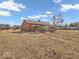 Single story brick home boasts mature landscaping, a large yard and lots of privacy at 1229 N German Church Rd, Indianapolis, IN 46229