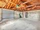 Oversized detached garage with overhead door, block walls and exposed beams at 1229 N German Church Rd, Indianapolis, IN 46229