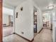 Hallway leading to living areas, highlighting neutral walls and flooring at 1229 N German Church Rd, Indianapolis, IN 46229