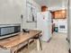 This kitchen features linoleum floors, wood cabinets, white appliances and a table near the microwave at 1229 N German Church Rd, Indianapolis, IN 46229
