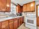 This kitchen showcases light-colored countertops, wood cabinets, and a white range oven at 1229 N German Church Rd, Indianapolis, IN 46229