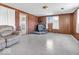 The living room includes a brick accent wall and fireplace, as well as wood-paneled walls at 1229 N German Church Rd, Indianapolis, IN 46229