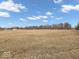 Vast open field showcasing a large lot, offering endless possibilities for development or recreation at 1229 N German Church Rd, Indianapolis, IN 46229