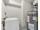 Utility room equipped with a Rheem water heater and a washing machine at 1229 N German Church Rd, Indianapolis, IN 46229