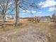 The yard is expansive, with mature trees enhancing its depth and character at 1229 N German Church Rd, Indianapolis, IN 46229