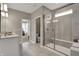 Bright bathroom featuring a glass-enclosed shower with a built-in bench and neutral tile at 1249 Sika Ln, Greenwood, IN 46143