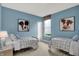 Charming bedroom with blue walls, twin beds, and decor at 1249 Sika Ln, Greenwood, IN 46143