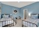 Charming bedroom with blue walls, twin beds, and decor at 1249 Sika Ln, Greenwood, IN 46143