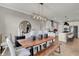 Open-concept dining room showcasing wooden table, modern light fixture, and flows into kitchen with white cabinetry at 1249 Sika Ln, Greenwood, IN 46143