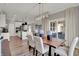 Dining room showcasing a wooden table, modern chandelier, and an open view of the adjacent kitchen area at 1249 Sika Ln, Greenwood, IN 46143