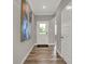 Inviting entryway with hardwood flooring, white trim, and an abstract art piece at 1249 Sika Ln, Greenwood, IN 46143