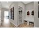 Hallway with wood flooring and a view into the laundry room and front room at 1249 Sika Ln, Greenwood, IN 46143