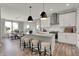 Bright kitchen featuring white cabinetry, stainless steel appliances, a center island with stool seating, and pendant lighting at 1249 Sika Ln, Greenwood, IN 46143
