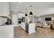 Open-concept kitchen with stainless appliances, white cabinetry, and breakfast bar overlooking living area at 1249 Sika Ln, Greenwood, IN 46143