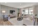 Inviting living room with gray paneled wall, plush seating, and abundant natural light at 1249 Sika Ln, Greenwood, IN 46143