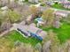 Overhead view featuring a blue house, complete with a private backyard swimming pool and beautifully landscaped grounds at 1250 W 141St St, Carmel, IN 46032