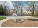 Backyard view of an in-ground pool and fire pit with an outdoor lounge area on a concrete deck at 1250 W 141St St, Carmel, IN 46032