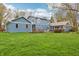 Beautifully maintained backyard highlighting a wooden deck and a sunroom extension to the house at 1250 W 141St St, Carmel, IN 46032
