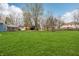 Expansive backyard featuring a lush green lawn and mature trees, perfect for outdoor activities and relaxation at 1250 W 141St St, Carmel, IN 46032