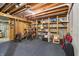 Unfinished basement area with exposed ceiling, storage shelves, and potential for customization at 1250 W 141St St, Carmel, IN 46032