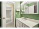 Modern bathroom with a white sink vanity, a well-lit mirror, and an open doorway to an adjacent room at 1250 W 141St St, Carmel, IN 46032