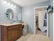 Well-lit bathroom with a vanity, sink, and a walk-in closet with lots of storage at 1250 W 141St St, Carmel, IN 46032