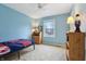 Cozy bedroom with a ceiling fan, neutral carpet, and a large window providing plenty of natural light at 1250 W 141St St, Carmel, IN 46032