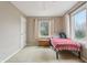 Cozy bedroom with neutral carpet, a window with curtains, and minimal decor with a ceiling fan at 1250 W 141St St, Carmel, IN 46032