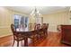 Bright dining room featuring a large window for natural light, a chandelier, and hardwood floors, creating a warm atmosphere at 1250 W 141St St, Carmel, IN 46032