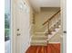 Inviting entryway with hardwood floors and staircase leading to the upper level at 1250 W 141St St, Carmel, IN 46032