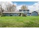 Inviting blue home with a large front lawn and manicured shrubs, exuding curb appeal and a welcoming ambiance at 1250 W 141St St, Carmel, IN 46032